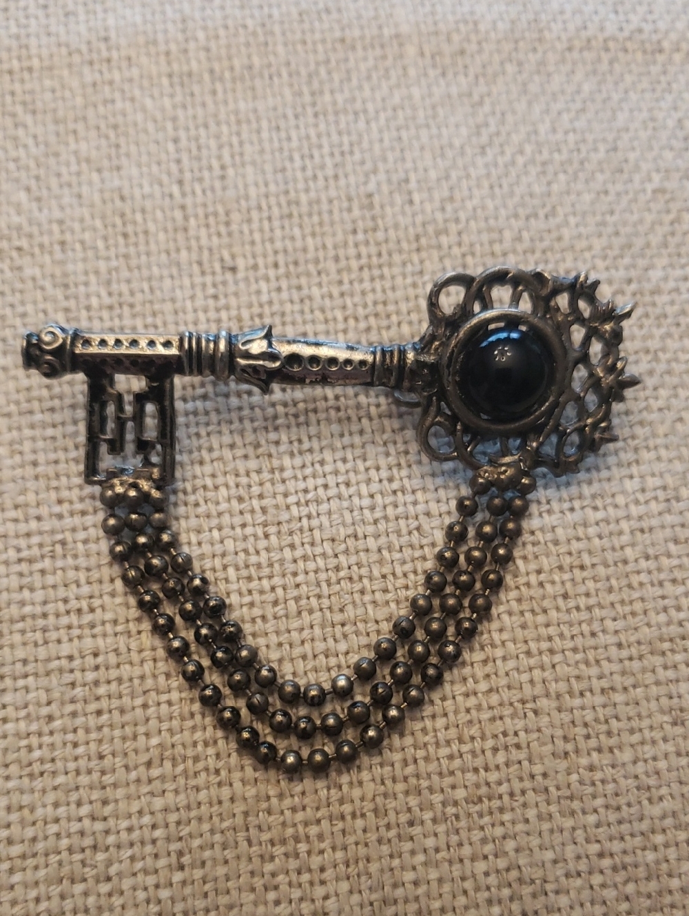 Vintage Silver-Toned Key Brooch with Black Cabochon and Chain